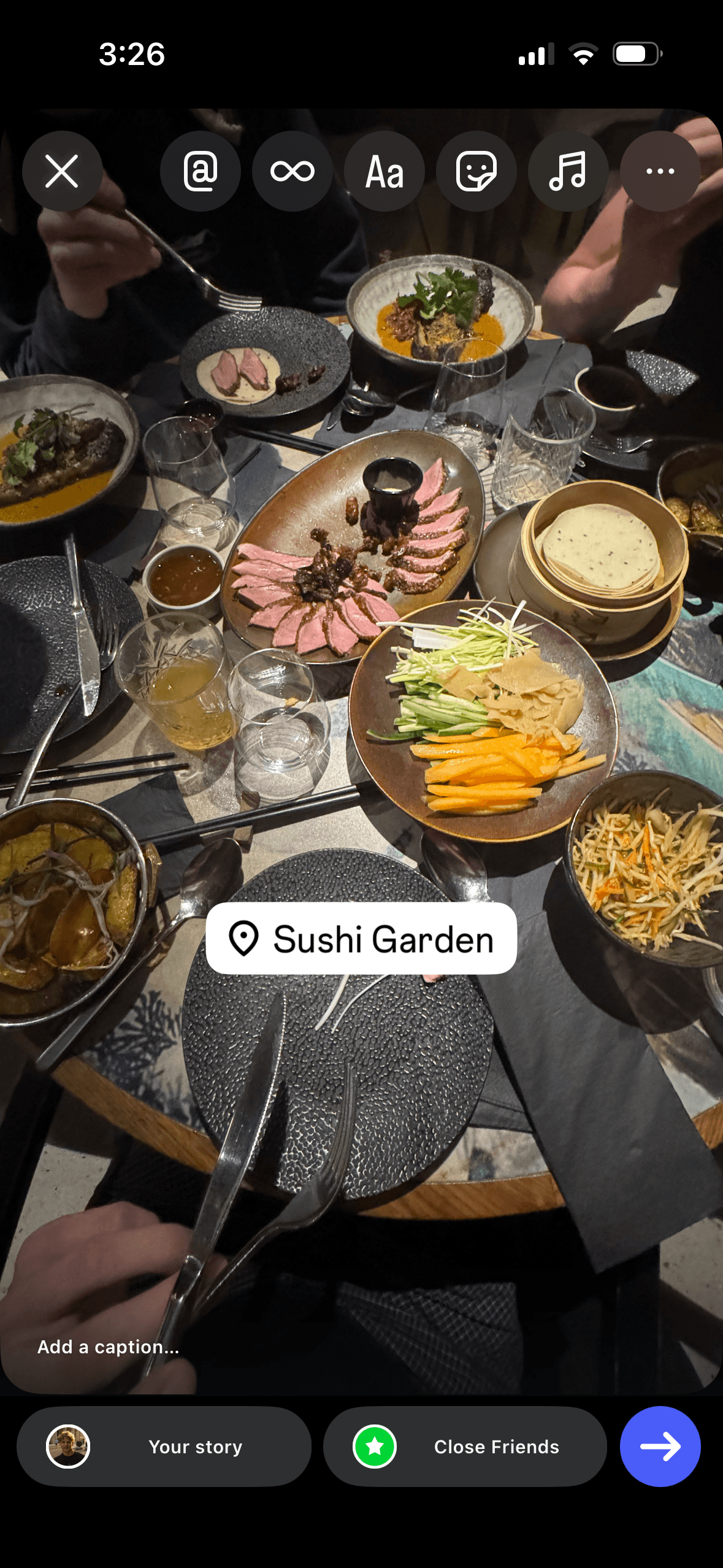 Instagram story creation screen showing a table full of sushi dishes with a Sushi Garden location tag